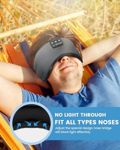 Man relaxing in hammock wearing a sleep mask with no light through nose bridge feature.